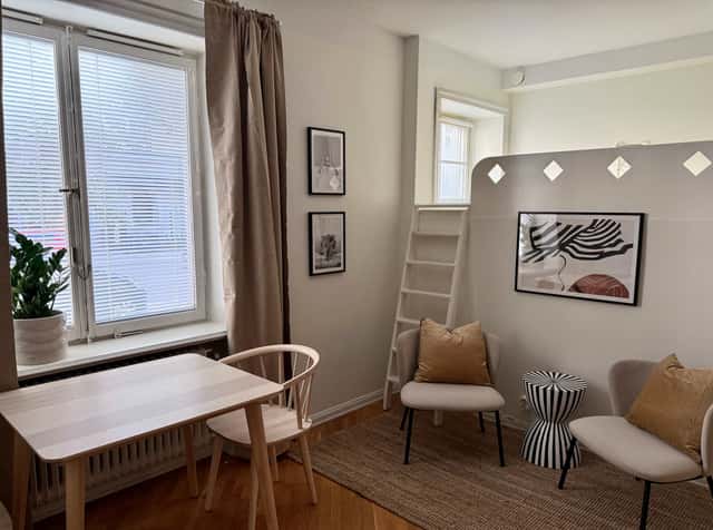 Södermalm studio interior, cozy living area by the water, modern kitchenette, café-lined streets nearby
