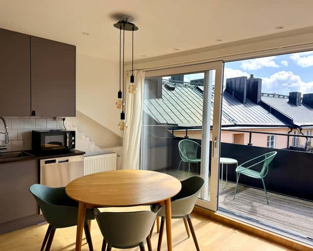 Open-plan kitchen dining area in a top-floor two-bedroom city apartment