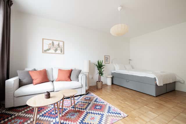 Studio apartment interior, kitchenette, cozy living area, local cafés and shops nearby, Sundbyberg