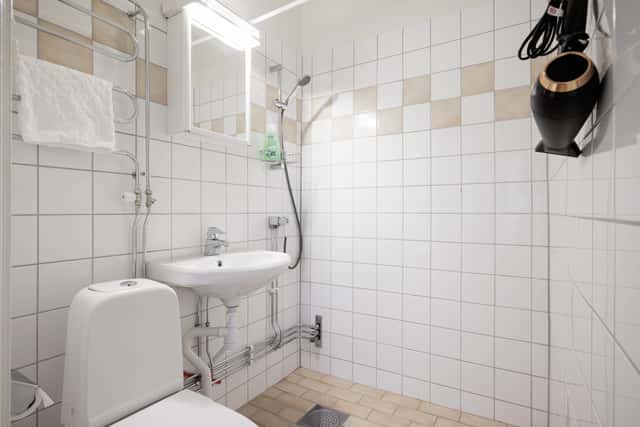 Studio apartment interior, kitchenette, cozy living area, local cafés and shops nearby, Sundbyberg