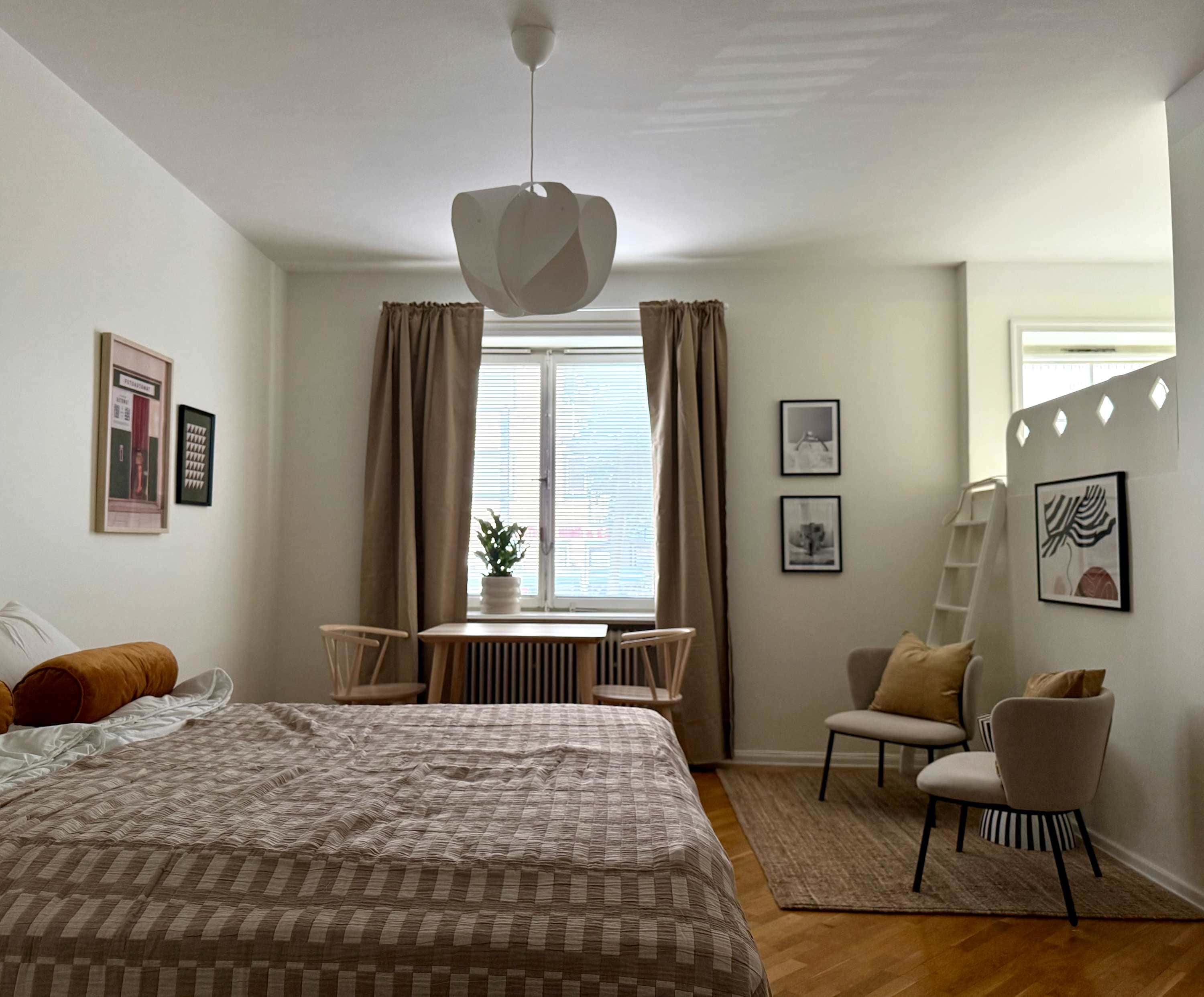 Södermalm studio interior, cozy living area by the water, modern kitchenette, café-lined streets nearby