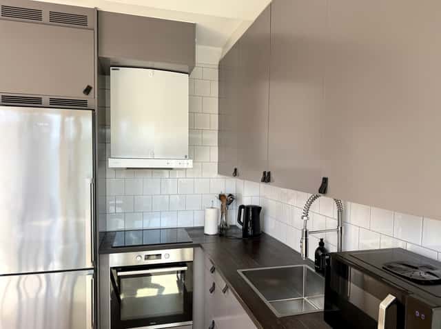 Open-plan kitchen dining area in a top-floor two-bedroom city apartment