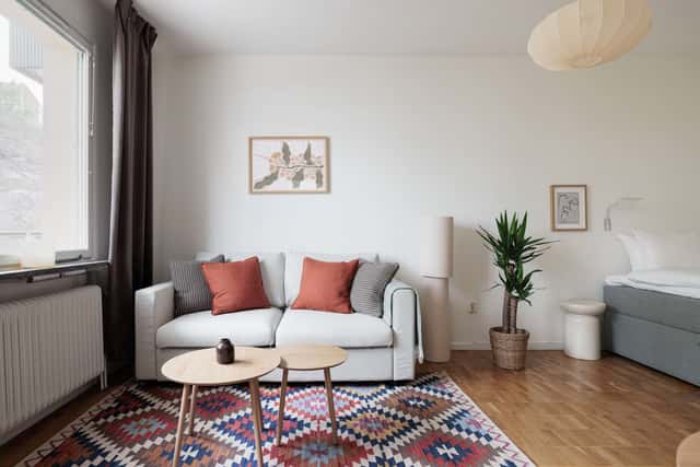 Studio apartment interior, kitchenette, cozy living area, local cafés and shops nearby, Sundbyberg
