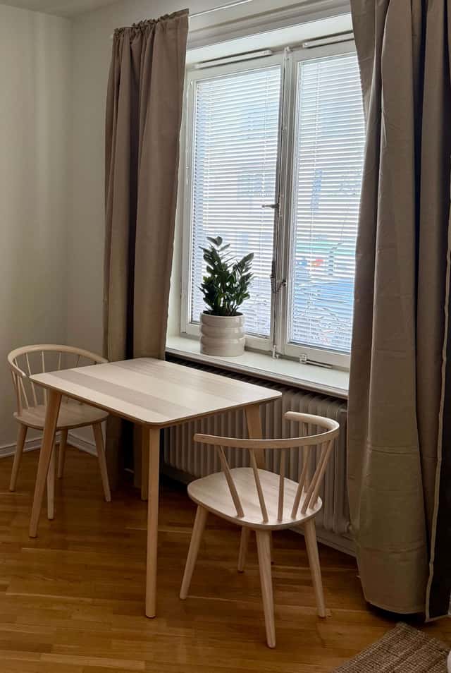 Södermalm studio interior, cozy living area by the water, modern kitchenette, café-lined streets nearby
