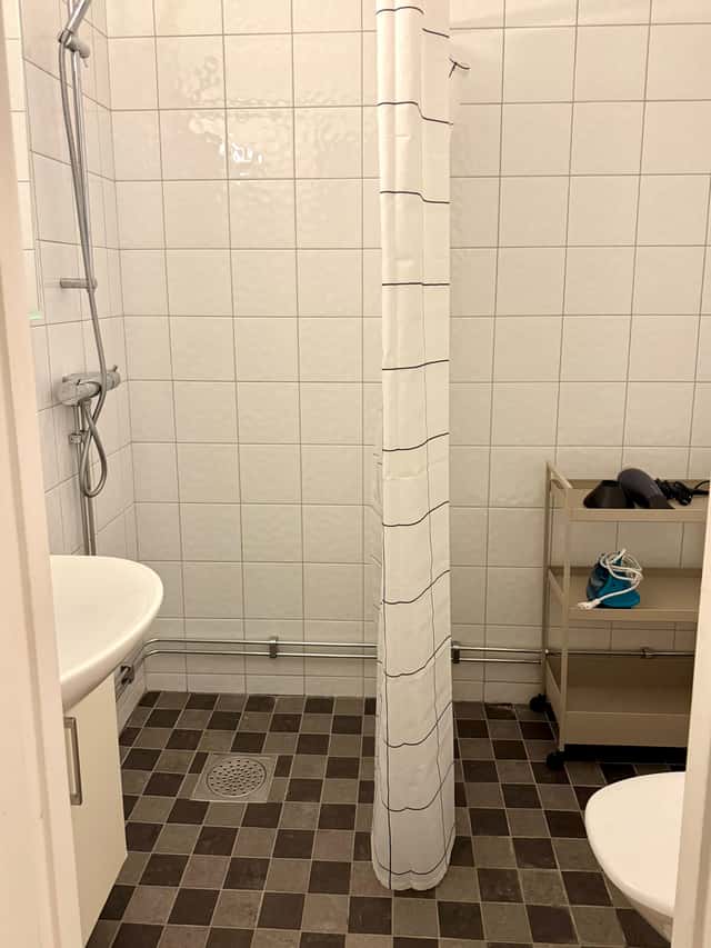 Södermalm studio interior, cozy living area by the water, modern kitchenette, café-lined streets nearby