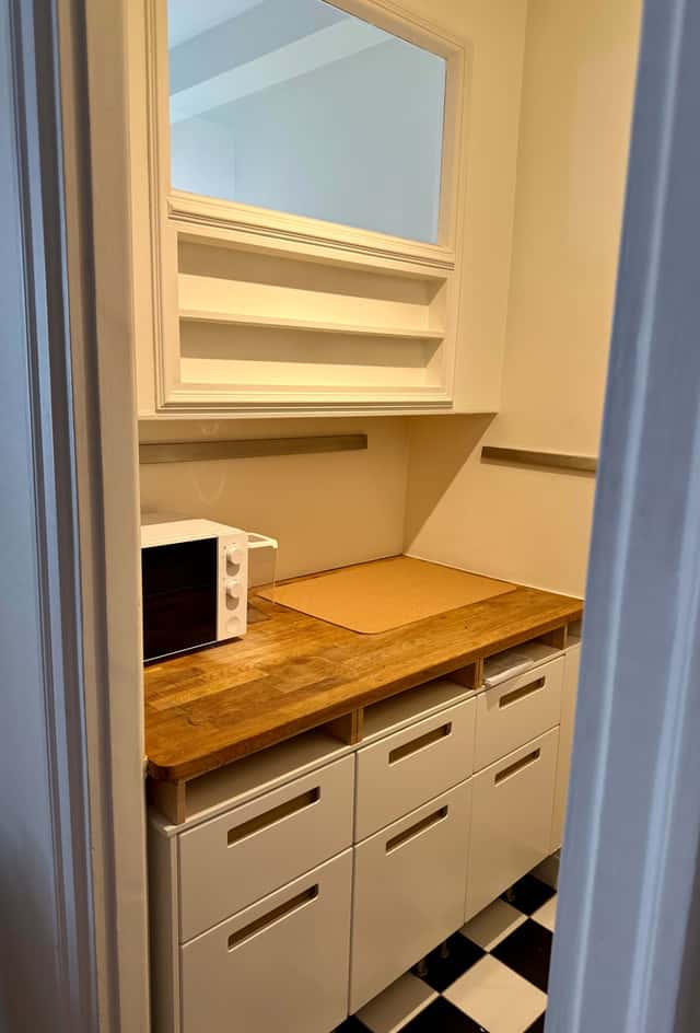 Södermalm studio interior, cozy living area by the water, modern kitchenette, café-lined streets nearby