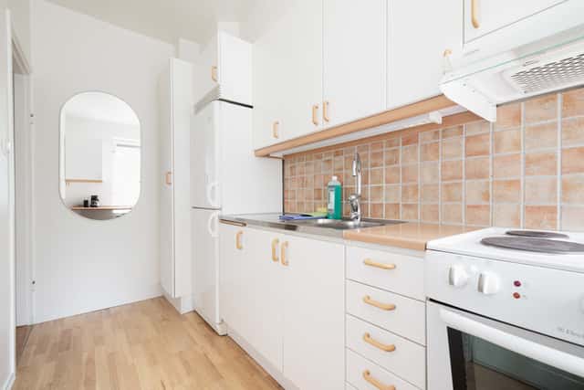 Studio apartment interior, kitchenette, cozy living area, local cafés and shops nearby, Sundbyberg