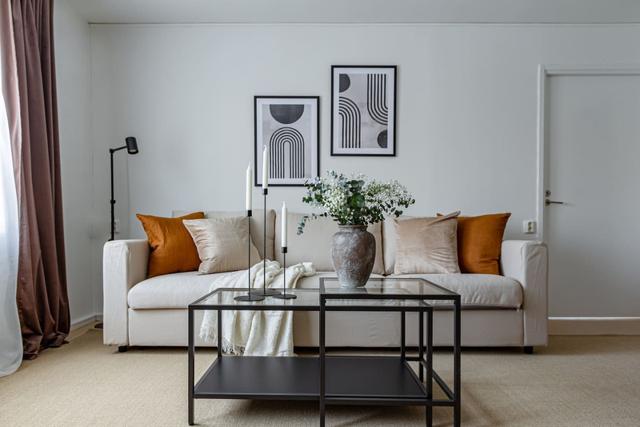 Living room with sofa bed and dining table in Södermalm apartment