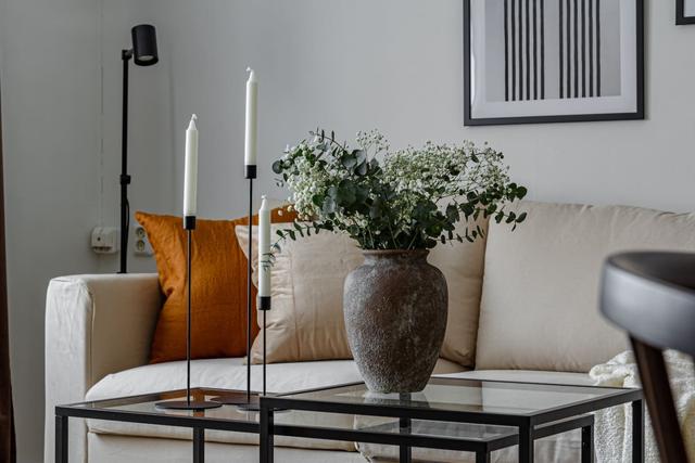 Living room with sofa bed and dining table in Södermalm apartment