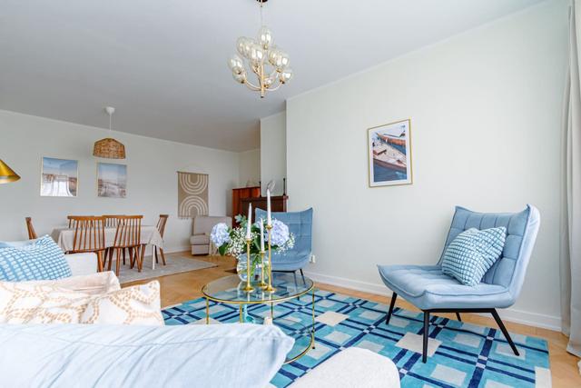 Living room with sofa bed and armchair in Kungsholmen apartment.