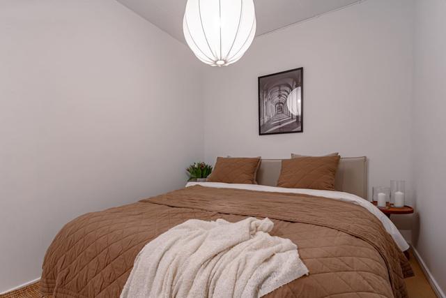 Living room with dining table and sofa bed in Södermalm apartment.