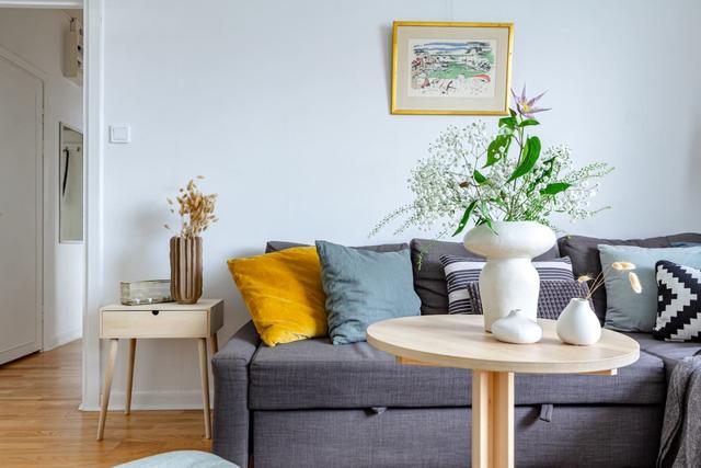 Comfortable living room with balcony access in Globen apartment