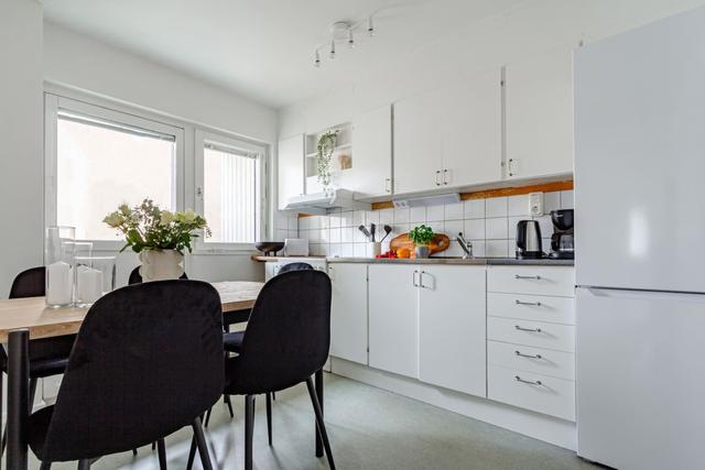 Living room with sofa bed and office space in Södermalm apartment