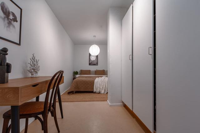 Living room with sofa bed and dining table in Södermalm apartment