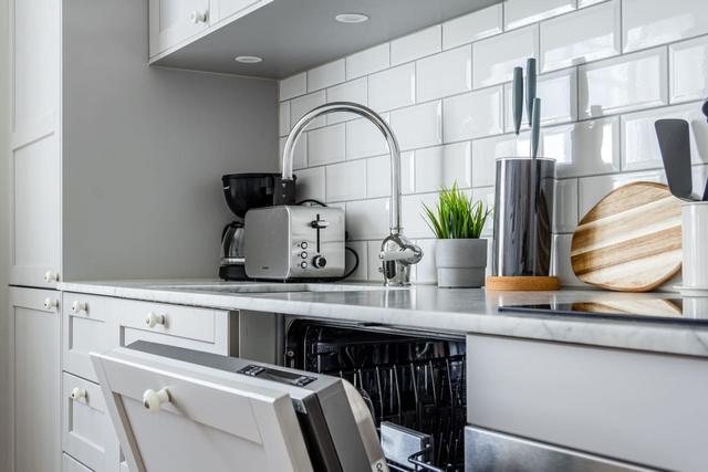 Open-concept living room and kitchen in a stylish apartment.