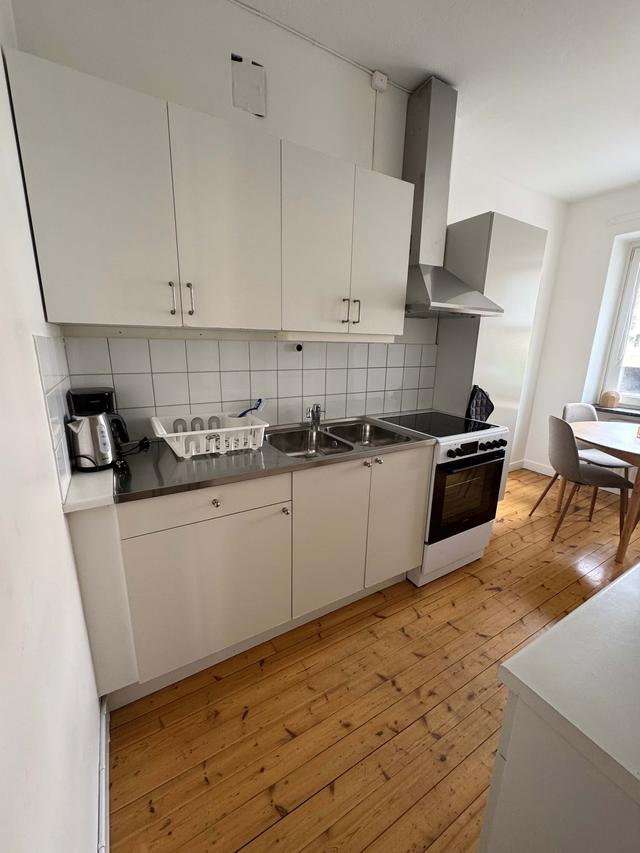 Cozy one-bedroom apartment interior in Sundbyberg with workspace and separate kitchen