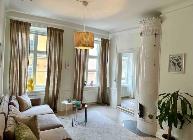 Cozy master bedroom with antique fireplace in Stockholm Old Town