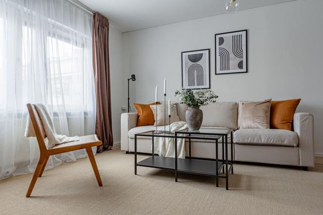 Living room with sofa bed and dining table in Södermalm apartment