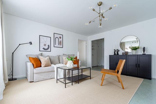 Living room with sofa bed and office space in Södermalm apartment