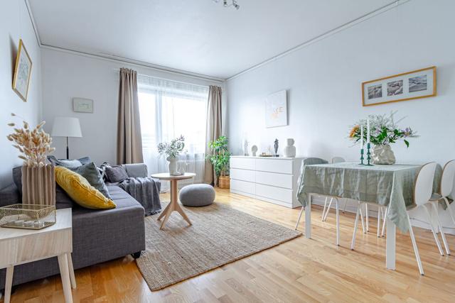 Comfortable living room with balcony access in Globen apartment