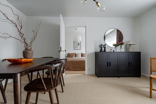 Living room with dining table and sofa bed in Södermalm apartment.