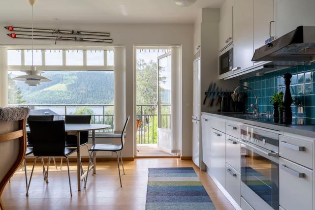 Spacious kitchen in Åre apartment with balcony access