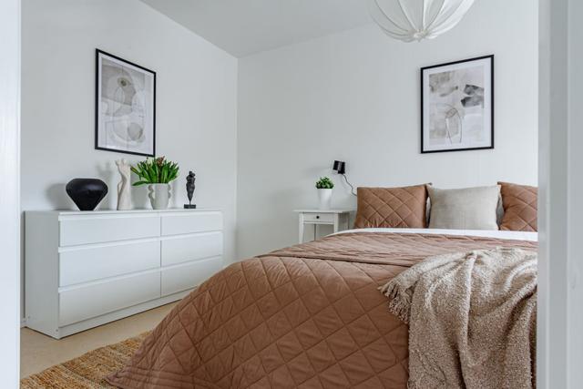 Living room with sofa bed and dining table in Södermalm apartment