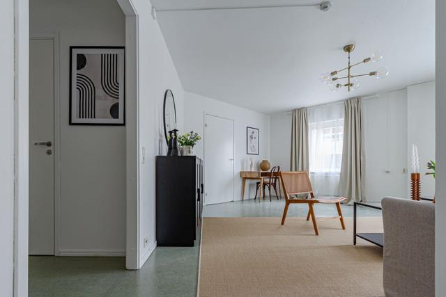 Living room with sofa bed and office space in Södermalm apartment