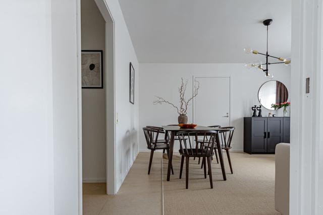 Living room with sofa bed and dining table in Södermalm apartment