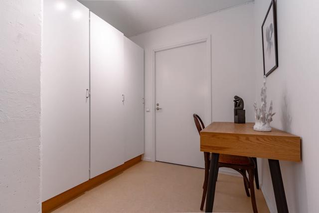 Living room with dining table and sofa bed in Södermalm apartment.