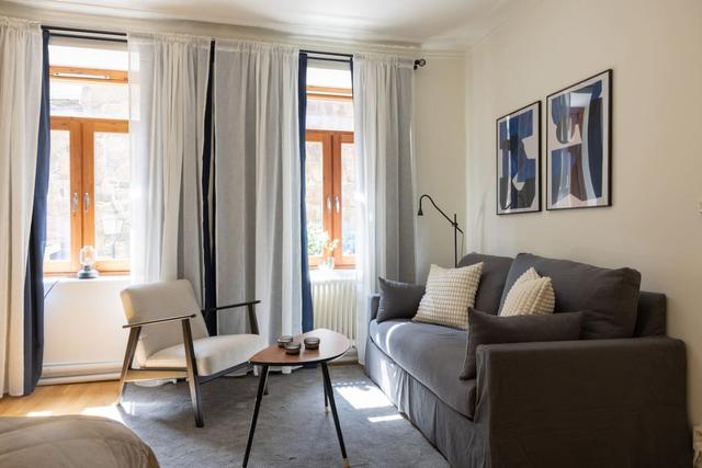 Cozy dining area for two by the large window in Gothenburg.