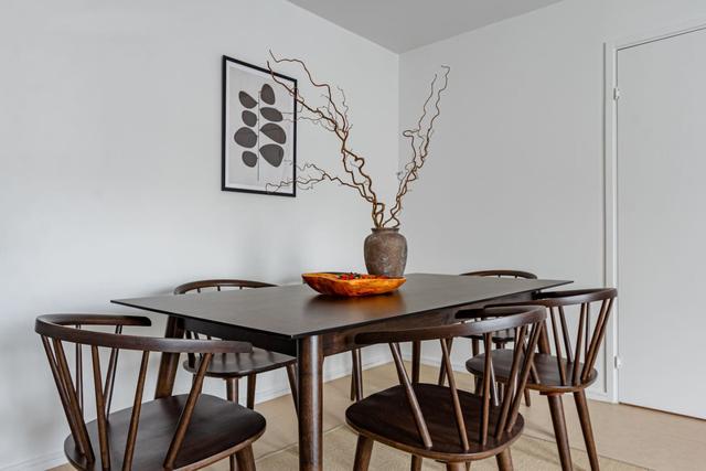 Living room with dining table and sofa bed in Södermalm apartment.