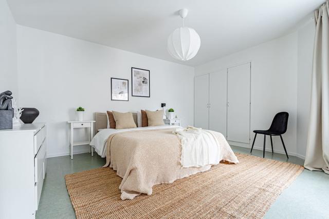 Living room with sofa bed and office space in Södermalm apartment