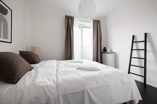 Balcony view in Sundbyberg apartment; Fully equipped kitchen in Sundbyberg; Cozy bedroom with double bed in Sundbyberg
