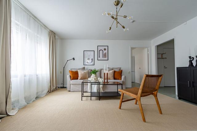 Living room with sofa bed and office space in Södermalm apartment