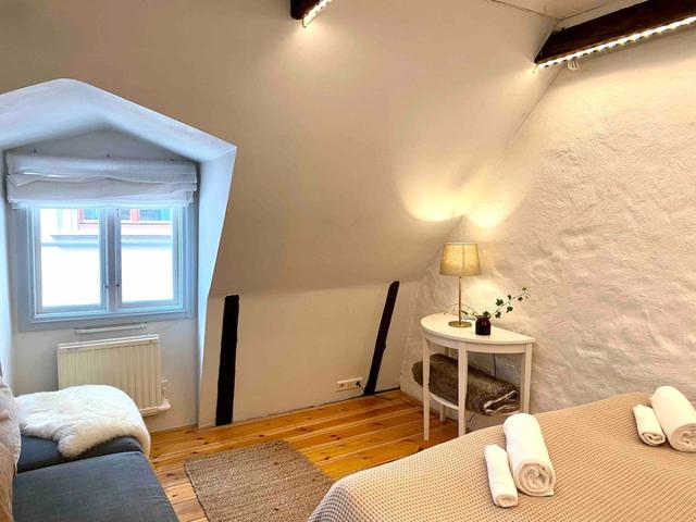 Loft apartment in Stockholm's Old Town with wooden beams.