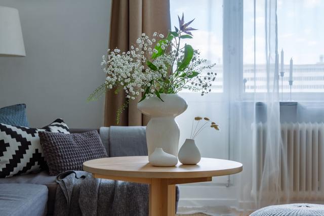 Comfortable living room with balcony access in Globen apartment