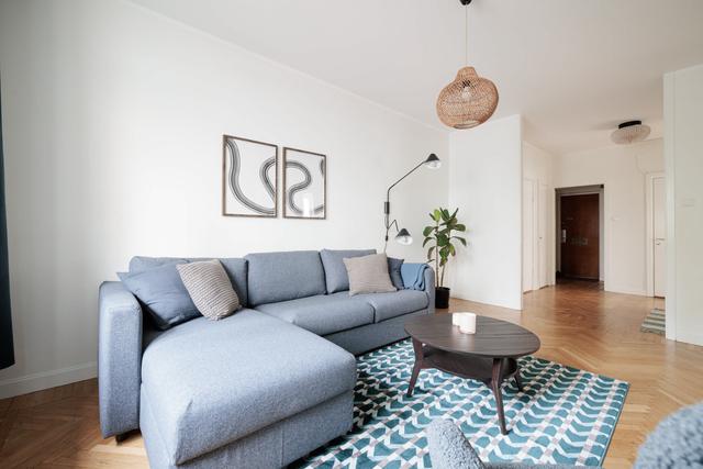 Ljust lägenhetsinteriör i Sundbyberg med minimalistisk inredning och grönskande omgivningar