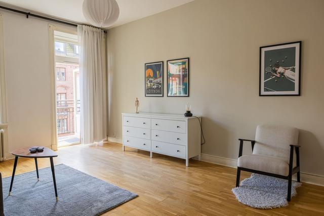 Living room with a convertible sofa in central Gothenburg apartment.