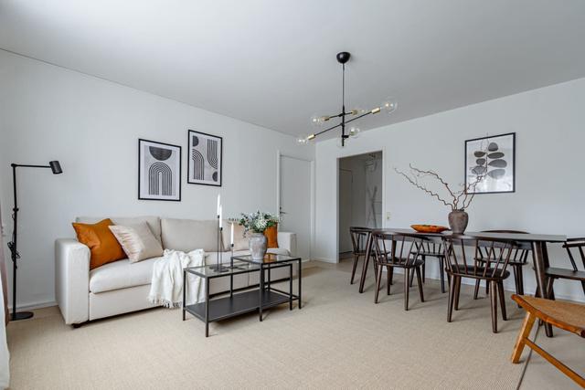 Living room with dining table and sofa bed in Södermalm apartment.