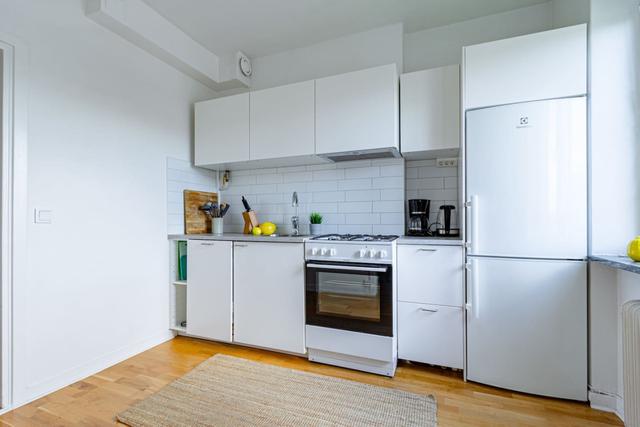 Comfortable living room with balcony access in Globen apartment