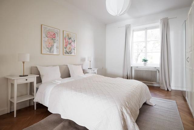 Living room in Vasastan apartment with large windows