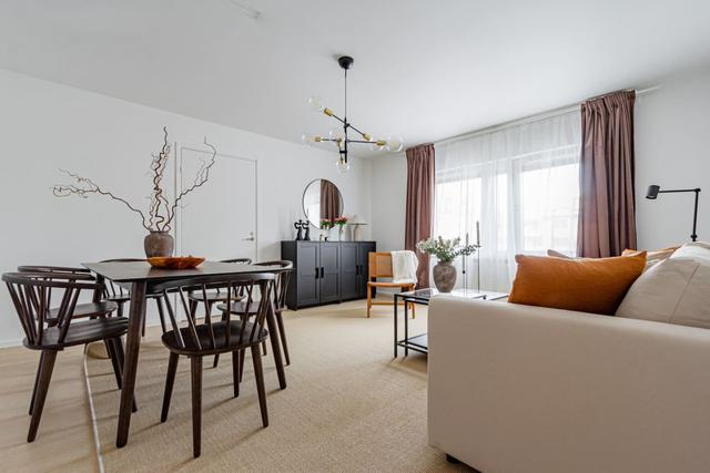 Living room with sofa bed and dining table in Södermalm apartment