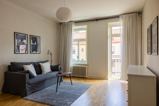 Living room with a convertible sofa in central Gothenburg apartment.