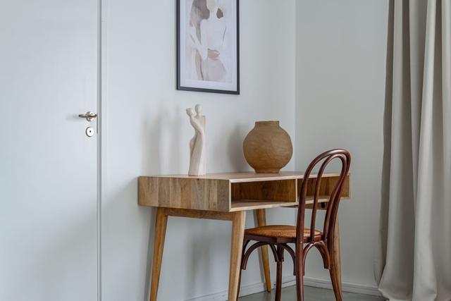 Living room with sofa bed and office space in Södermalm apartment