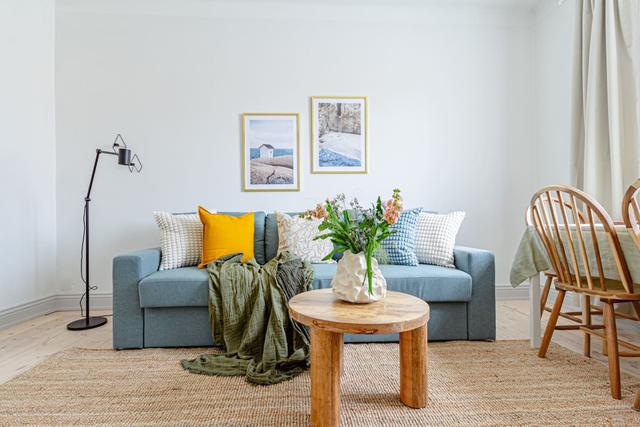 Open-concept living room and kitchen in a stylish apartment.