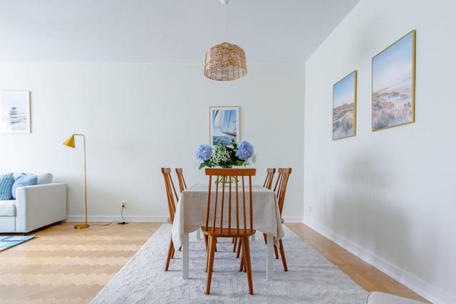 Living room with sofa bed and armchair in Kungsholmen apartment.