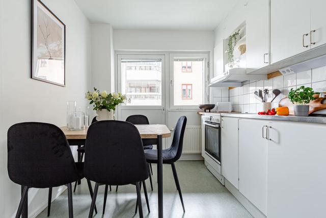 Living room with sofa bed and office space in Södermalm apartment