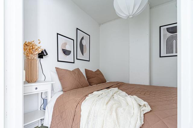 Living room with sofa bed and office space in Södermalm apartment