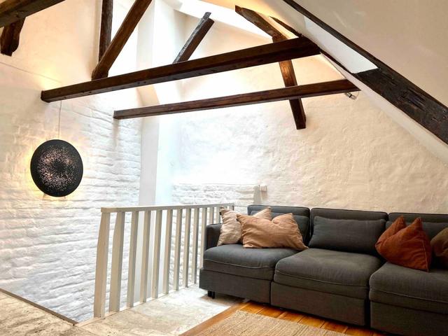 Loft apartment in Stockholm's Old Town with wooden beams.